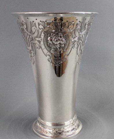 Impressive large silver trophy with decorations  on  the top and bottom.   
5000 m2 showroom.