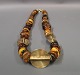 African inspired amber necklace adorned with brass pieces. Length 60 cm. 5000 m2 
showroom.
