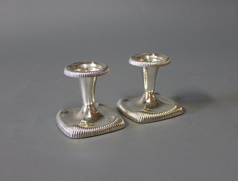 A pair of low candlesticks in 830 silver no.: 432 stamped M. G. & S. 
5000m2 showroom.