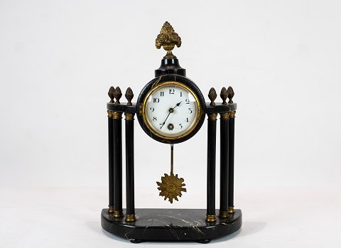 Antique French Fireplace clock from around 1840 with flame gilding.
5000m2 showroom.