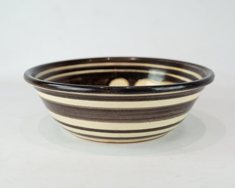 Ceramic bowl in 
white and brown colours decorated with fish by Humlebæk Ceramics.
5000m2 showroom.