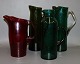 Brightly colored glass jugs.
4 different in green and one in red. 
5000 m2 showroom.