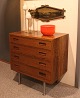 Small rosewood chest of drawers with steel legs.  
5000m2 showroom.