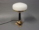 Tablelamp in brass with Black stem and White glass dome. The lamp is signed 
M.M.M.
5000m2 showroom.