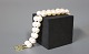 Bracelet of cultured Pearls with a 14ct. gold Lock with four diamonds. 
5000m2 showroom.
