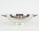 Bowl on foot with handles and decorated with carvings of hallmarked silver.
5000m2 showroom.