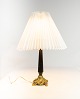 Table lamp with black patinated stem and gilded foot with shade of paper.
5000m2 showroom.