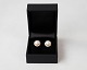 Set of earrings of 18 carat gold with pink cultured pearls circled by 21 smaller 
diamonds.
5000m2 showroom.